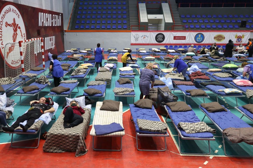 Temporary accommodation for people evacuated from Donetsk People's Republic in Russia's Rostov-on-Don RegionTAGANROG, ROSTOV-ON-DON REGION, RUSSIA  FEBRUARY 20, 2022: People evacuated from the Donetsk People's Republic are seen at a sports centre. Amid the escalating conflict in east Ukraine, on February 18, 2022, the heads of the Lugansk and Donetsk People's Republics announced a mass evacuation of civilians to Russia. Over 40 thousand residents of the Donetsk and Lugansk People's Republics have arrived in Russia's Rostov-on-Don Region. Erik Romanenko/TASS (Photo by Erik Romanenko\TASS via Getty Images)Erik Romanenkotemporary accommodation, bed, folding bed