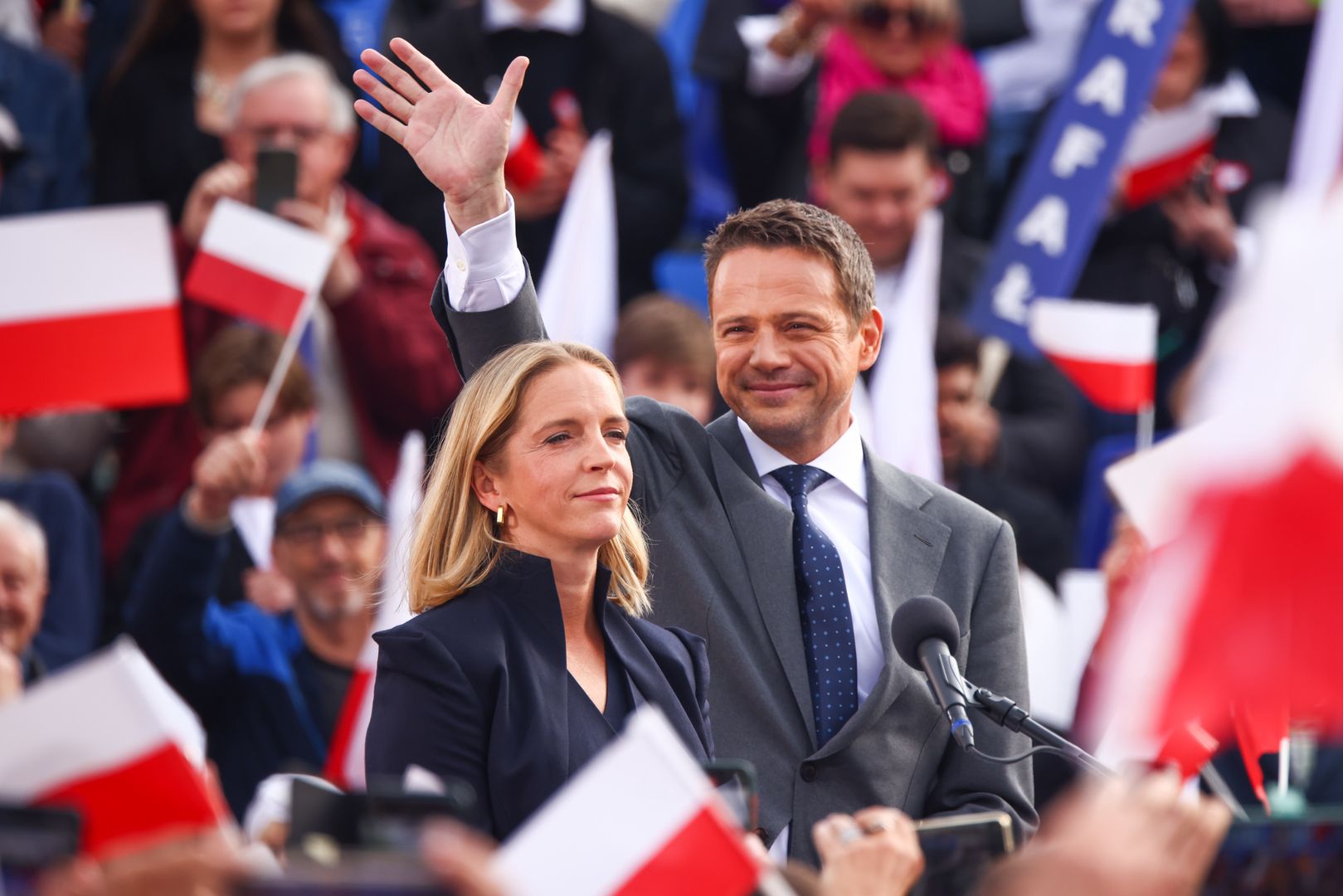 Rafal Trzaskowski, the mayor o Warsaw and the candidate of the Civic Platform (PO) in the upcoming presidential election, and his wife Malgorzata Trzaskowska, attend a campaign rally at the Main Square in Krakow, Poland on May 13, 2025.  (Photo by Beata Zawrzel/NurPhoto via Getty Images)