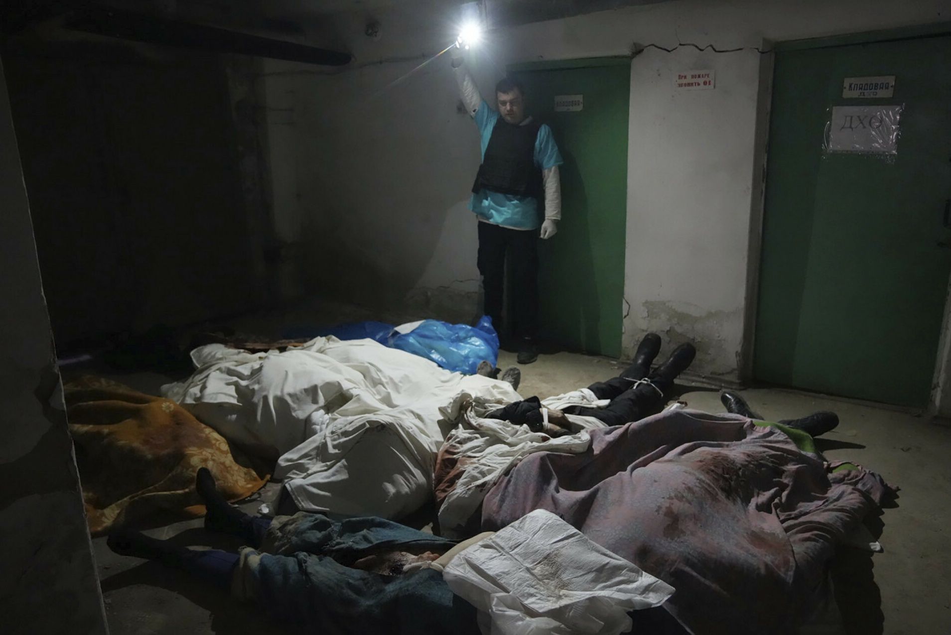 Wojna w Ukrainie. Policjant z Mariupola pokazuje ciała osób zabitych w wyniku ostrzału. Wśórd ofiar jest także noworodekA police officer shows the covered bodies of people killed by shelling at hospital number 3 in Mariupol, Ukraine, Tuesday, March 15, 2022. (AP Photo/Evgeniy Maloletka)AP