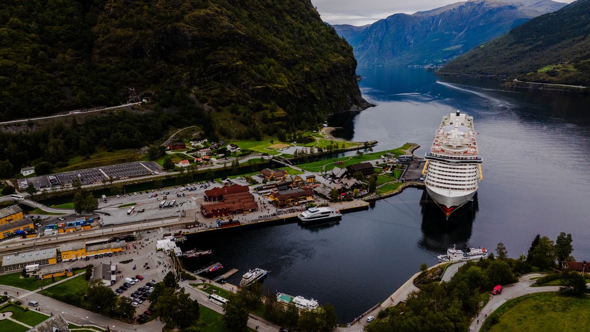 An aerial view shows the AIDA cruise ship docked in Flåm, Norway, on September 17, 2024. The village is located between steep cliffs and green hills. Flåm is a destination for fjord cruises and railway tourism.  (Photo by Manuel Romano/NurPhoto via Getty Images)