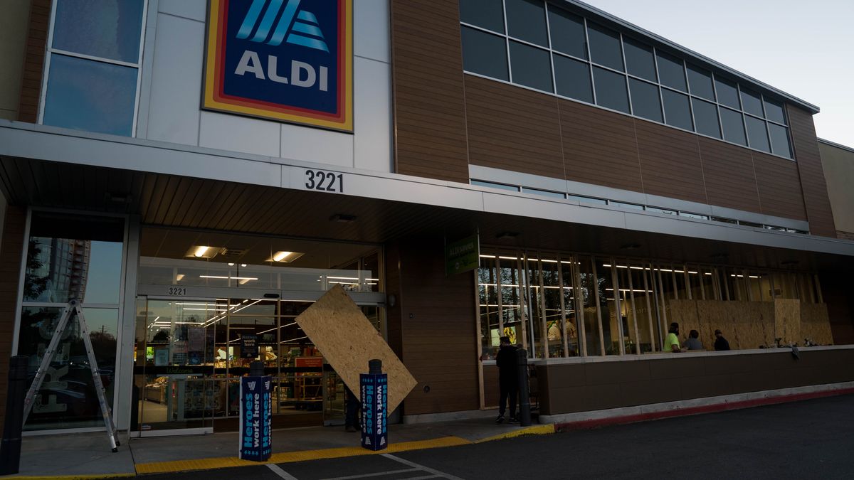ATLANTA, GA - NOVEMBER 03: Contractors board up an ALDI in Buckhead on November 3, 2020 in Atlanta, Georgia. Businesses in cities across the country are preparing for possible unrest as election results come in. (Photo by Megan Varner/Getty Images)