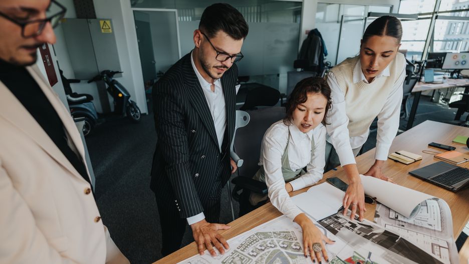 Team collaboration meeting discussing architectural project plansDiverse team gathers around a table to review architectural project plans. The project leader, using crutches, guides the discussion. Papers and a laptop are visible, enhancing the collaborative atmosphere.QUNICA_STUDIOteam, collaboration, project, meeting, architectural plans, discussion, project leader, crutches, office, business, planning, teamwork, diverse team, workspace, laptop, papers, strategy, creative, innovation, brainstorming, group, interacting, ideas, leadership, guidance, design, interior, focus, concentration, motivation, analysis, concept, collaborate, professional, industry, corporate, management, overview, architecture, layout, planning session, urban planning, team discussion, productive, workspace design, business meeting, team, collaboration, project, meeting, architectural plans, discussion, project leader, crutches, office, business, planning, teamwork, diverse team, workspace, laptop, papers, strategy, creative, innovation, brainstorming, group, interacting, ideas, leadership, guidance, design, interior, focus, concentration, motivation, analysis, concept, collaborate, professional, industry, corporate, management, overview, architecture, layout, planning session, urban planning, team discussion, productive, workspace design, business meeting