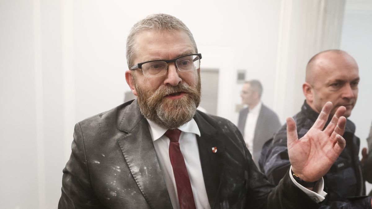 Grzegorz Braun, a member of the far-right Confederation party is seen after using a fire extinguisher on to put out candles on a menorah that was lit during Hannukah celebration in the parliament building in Warsaw, Poland on December 12, 2023.  (Photo by Beata Zawrzel/NurPhoto via Getty Images)