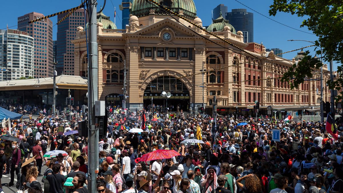 MELBOURNE, AUSTRALIA - JANUARY 26: Large crowds gather outside Flinders Street Station for the Invasion Day Rally on January 26, 2026 in Melbourne, Australia.  Australia Day, formerly known as Foundation Day, is the official national day of Australia and is celebrated annually on January 26 to commemorate the arrival of the First Fleet to Sydney in 1788. Many indigenous Australians refer to the day as 'Invasion Day' and there is a small but growing movement to change the date amid broader debate on the day's significance. This year's commemorations take on added significance in the wake of the Bondi shootings in December 2025. (Photo by Jesse Thompson/Getty Images)