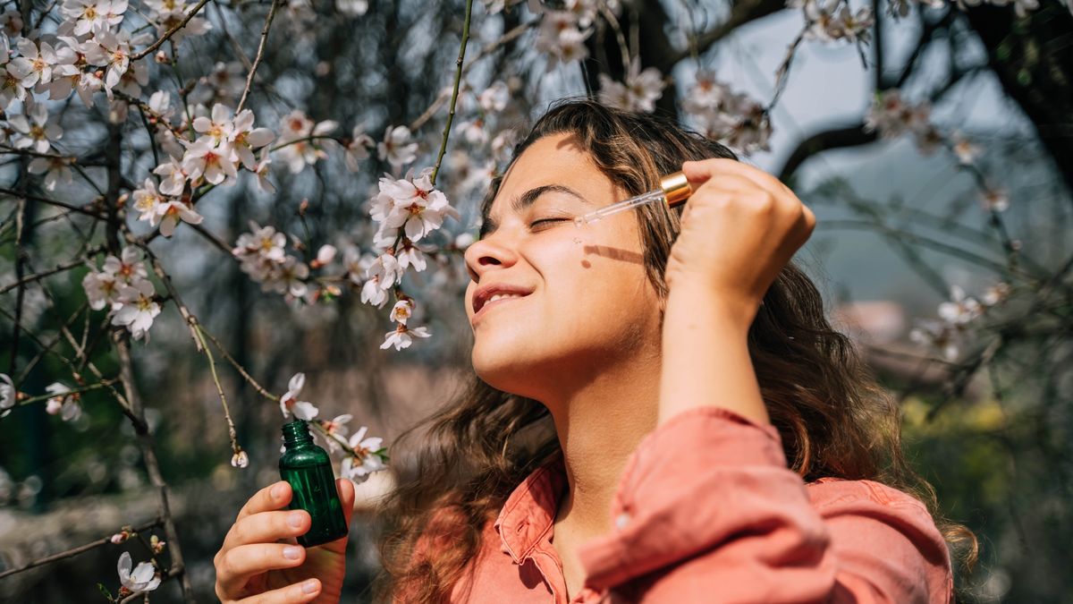 A beautiful woman with clean skin drips serum from a pipette on her face.
A beautiful woman with clean skin drips serum from a pipette on her face. Sakura on background.
Tatiana Maksimova
