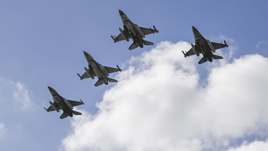 LISBON, PORTUGAL - APRIL 25: Portuguese Air Force F-16 M Fighting Falcons fly over Praça do Comercio during the military parade that opens the official ceremonies in celebration of the 50th anniversary of 1974 Carnation Revolution (Revolução dos Cravos) on April 25, 2024 in Lisbon, Portugal. Today marks the 50th anniversary of the Carnation Revolution (Revolução dos Cravos) led by the military and supported by the Portuguese people to overthrow the dictatorial regime of Estado Novo that became known as the Carnation Revolution. On April 25th 1974, democracy was restored, putting an end of 48 years of the National Dictatorship (1926-1933) and the Estado Novo of Salazar and Marcello Caetano (1933-1974) that were together the longest authoritarian regime in Western Europe during the 20th century. Ever since this 'Freedom Day' has been marked as a national holiday in Portugal. (Photo by Horacio Villalobos#Corbis/Getty Images)