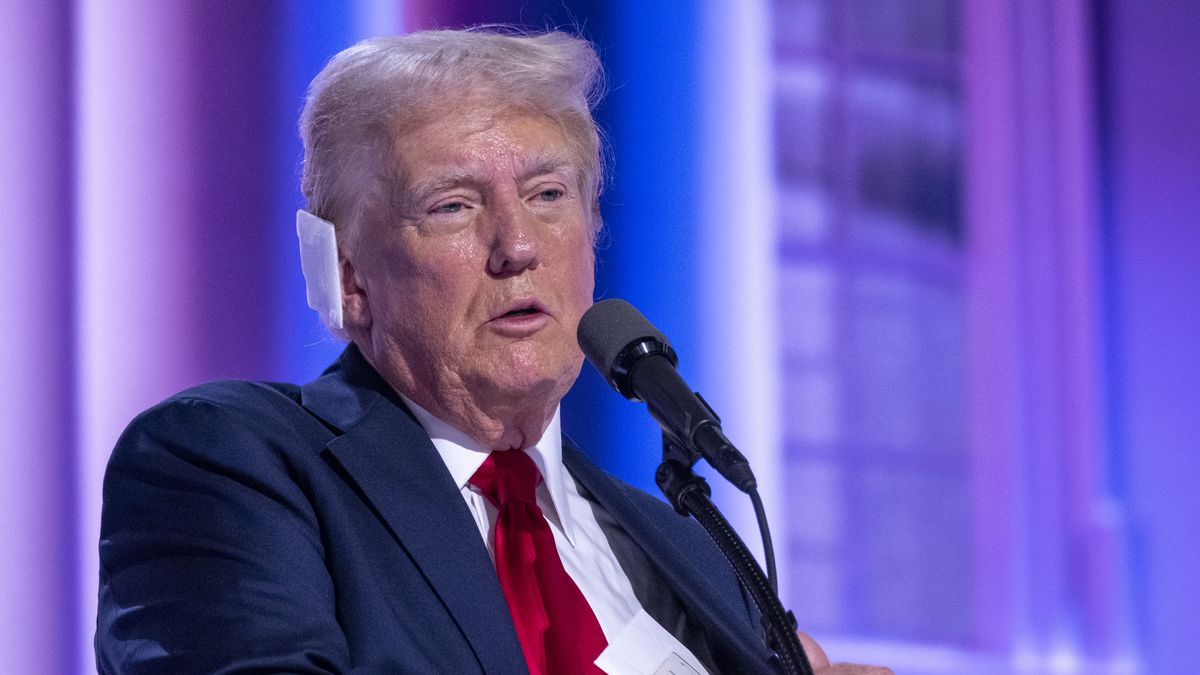 MILWAUKEE, WISCONSIN - JULY 18: Republican Presidential Nominee Donald Trump puts away a $1 million check to be donated to victims of his July 13 assassination attempt, at Fiserv Forum on July 18, 2024, on the final day of the Republican National Convention in downtown Milwaukee, Wis. (Photo by Joel Angel Juarez for The Washington Post via Getty Images)