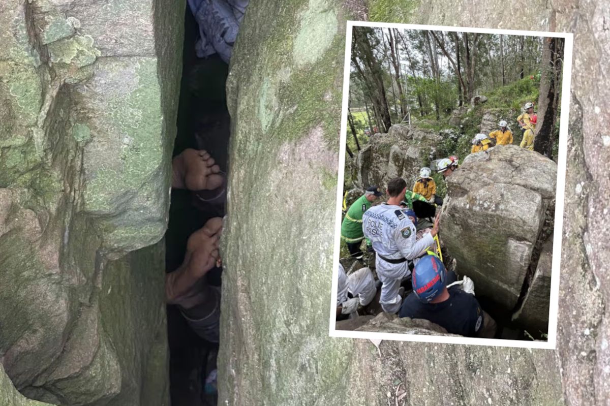 A woman trapped between enormous boulders.