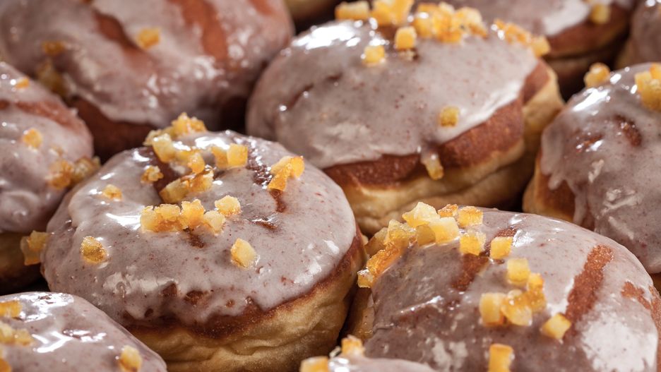 Fresh donuts with icing and orange peel
Close up of donuts with sugar icing and orange peel
Ohoho