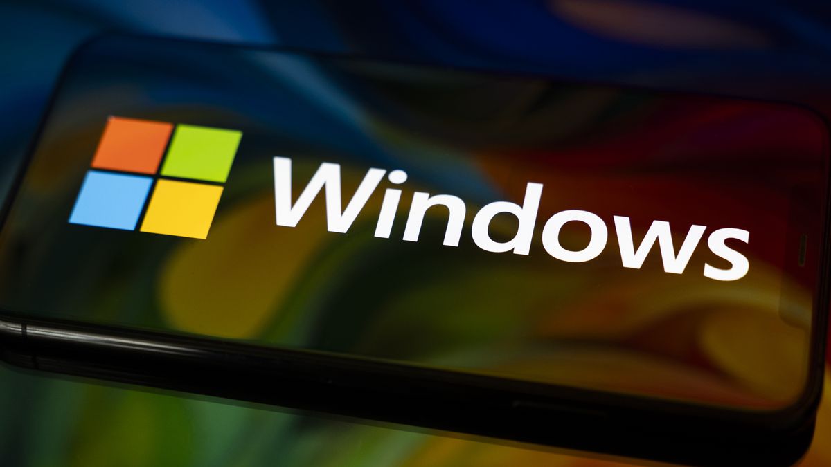 The Windows logo appears on the screen of a smartphone, which reflects an abstract illustration in Microsoft's colors of red, green, blue, and yellow. Microsoft releases a major update to Windows 11 (25H2), and support for Windows 10 ends definitively on October 14. In Creteil, France, on October 9, 2025. (Photo by Samuel Boivin/NurPhoto via Getty Images)