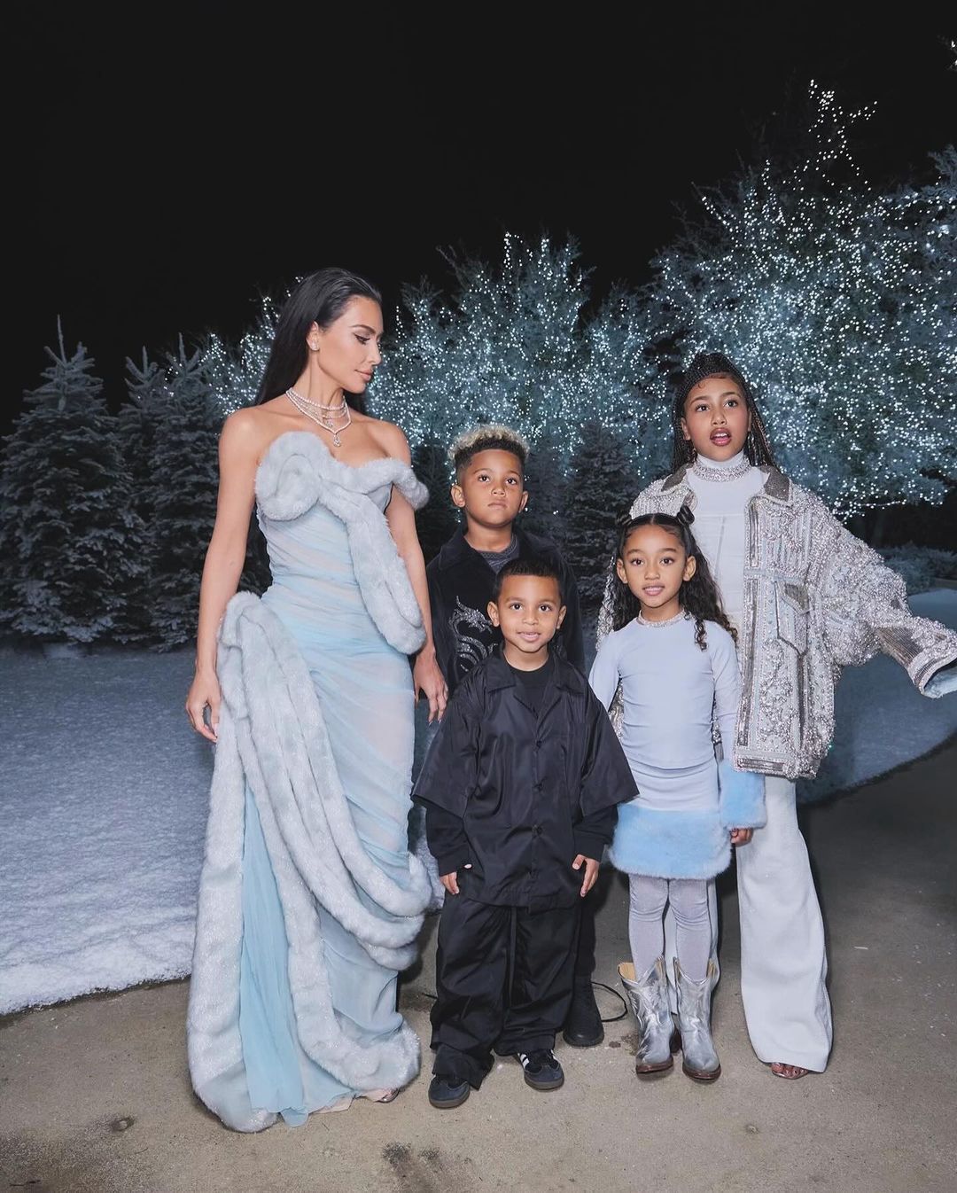 Kim Kardashian with children at a holiday party