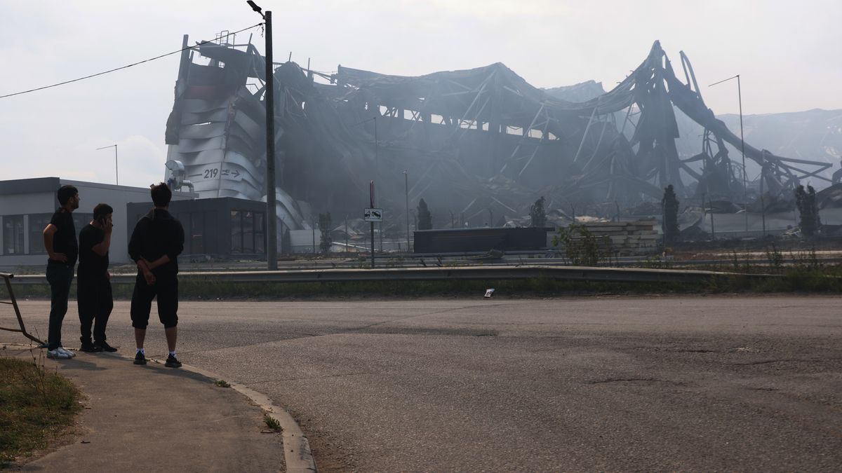 PODOLSK, RUSSIA - AUGUST 17: Passersby look at the burned-out warehouse of the logistics and trading company Wildberries in the Koledino industrial park, on August 17, 2026, in Podolsk, Russia. Seven out of 10 warehouses of Russia's largest trading company, Wildberries, or WB, have been attacked by Ukrainian drones and partially burned down in the past month. (Photo by Contributor/Getty Images)