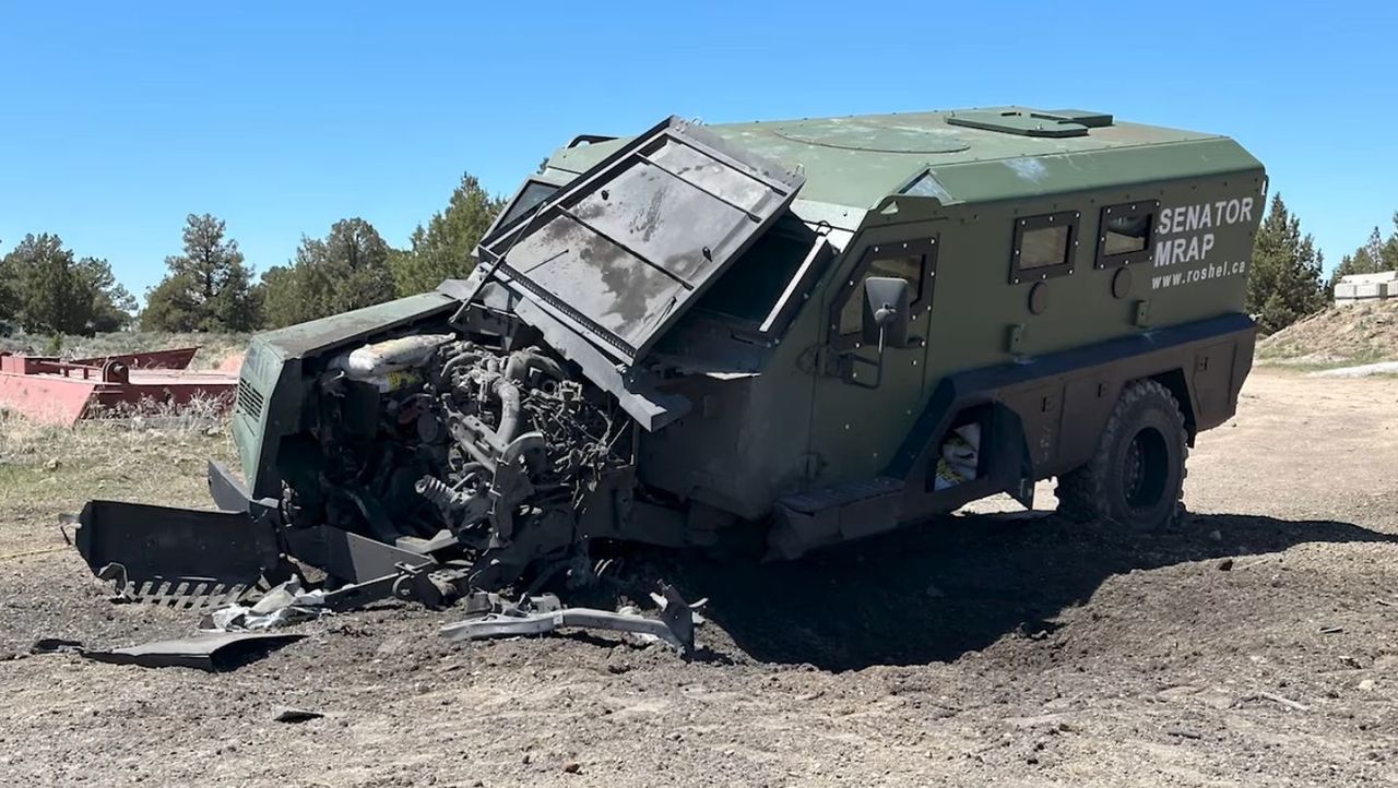 Senator MRAP after tests. There are visible major damages to the front of the vehicle after running over a mine, as well as an untouched crew cabin.