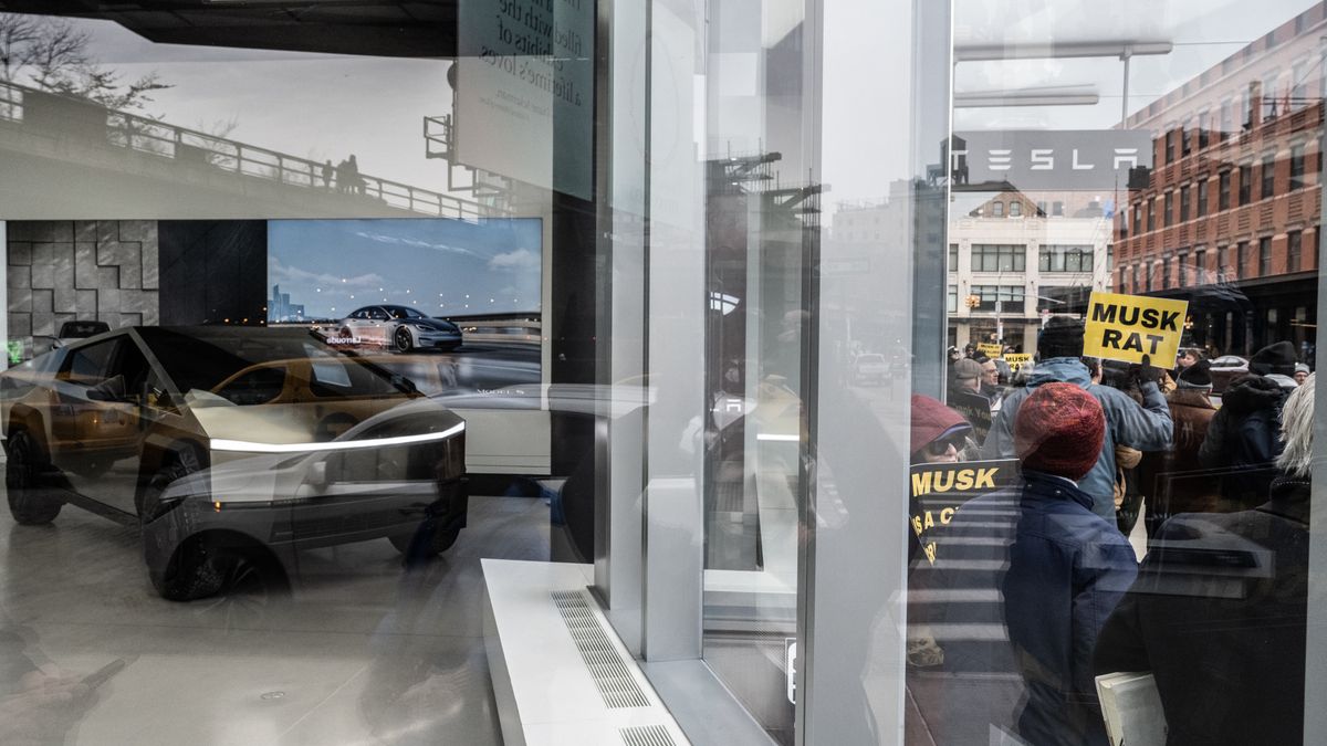 Protesters rally against Elon Musk's actions in the Trump administration  at a Tesla showroom in New York, US, on Saturday, Feb. 15, 2025. Elon Musk is facing the most direct legal challenge to date over the role he's assumed in the US government, with Democratic state officials and federal employees claiming that President Donald Trump has unconstitutionally delegated vast powers to the billionaire. Photographer: Stephanie Keith/Bloomberg via Getty Images
