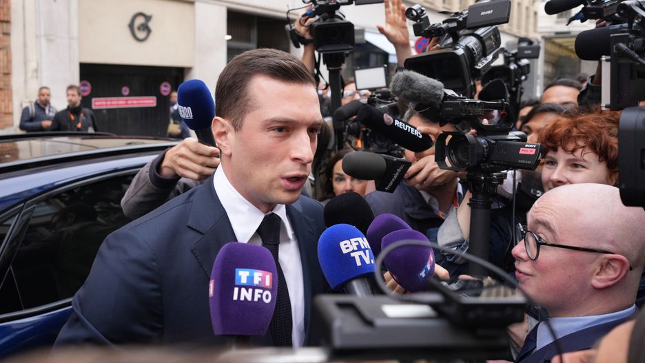 Jordan Bardella, president of the National Rally, speaks to members of the media as he arrives at Medef in Paris, France, on Thursday, June 20, 2024. The head of France's Medef business lobby criticized the campaign programs of both the far right and an alliance of leftist parties, saying they are a danger to the economy. Photographer: Nathan Laine/Bloomberg via Getty Images
