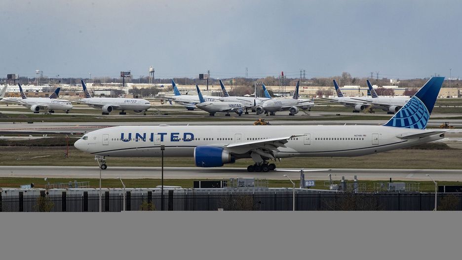 A United Airlines plane taxis by parked United jets at O&apos;Hare International Airport in Chicago on April 14, 2020. A woman has been charged with assault in a recent incident in which a flight attendant reported she was pushed several times by the passenger. (Brian Cassella/Chicago Tribune/Tribune News Service via Getty Images)