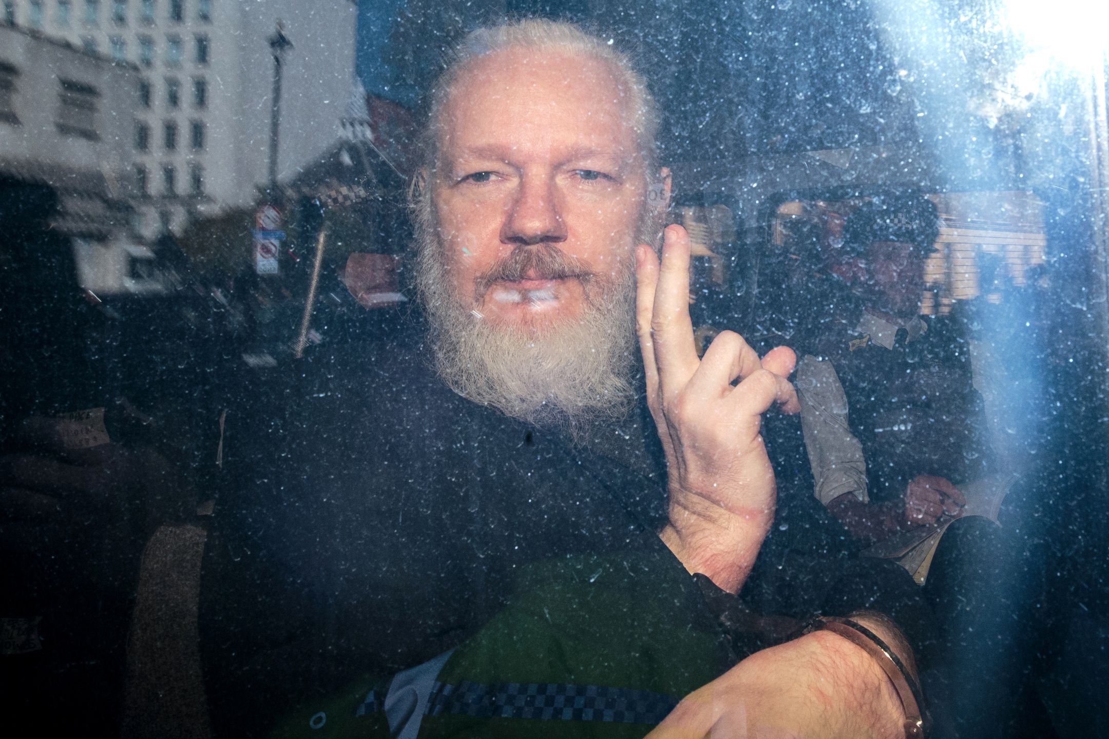 Julian Assange Appears At Westminster Magistrates CourtLONDON, ENGLAND - APRIL 11: Julian Assange gestures to the media from a police vehicle on his arrival at Westminster Magistrates court on April 11, 2019 in London, England.  After weeks of speculation Wikileaks founder Julian Assange was arrested by Scotland Yard Police Officers inside the Ecuadorian Embassy in Central London this morning. Ecuador's President, Lenin Moreno, withdrew Assange's Asylum after seven years citing repeated violations to international conventions. (Photo by Jack Taylor/Getty Images)Jack Taylorlondon, bestof, topix