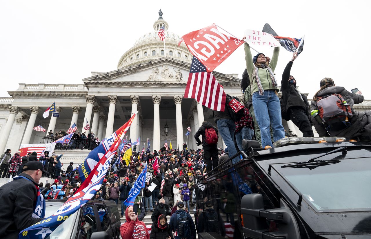 UNITED STATES - JANUARY 6: Trump supporters stand on the U.S. Capitol Police armored vehicle as others take over the steps of the Capitol on Wednesday, Jan. 6, 2021, as the Congress works to certify the electoral college votes. (Photo By Bill Clark/CQ-Roll Call, Inc via Getty Images)
