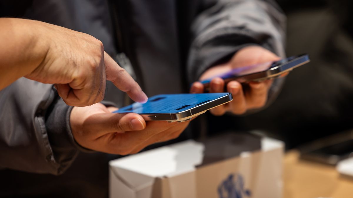 A customer look at an iPhone 15 smartphone at the new Apple Inc. store inside the Starfield mall during its opening in Hanam, South Korea, on Saturday, Dec. 9, 2023. Apple was due to open another store in the country simultaneously, but it now appears that one is running behind. Photographer: SeongJoon Cho/Bloomberg via Getty Images