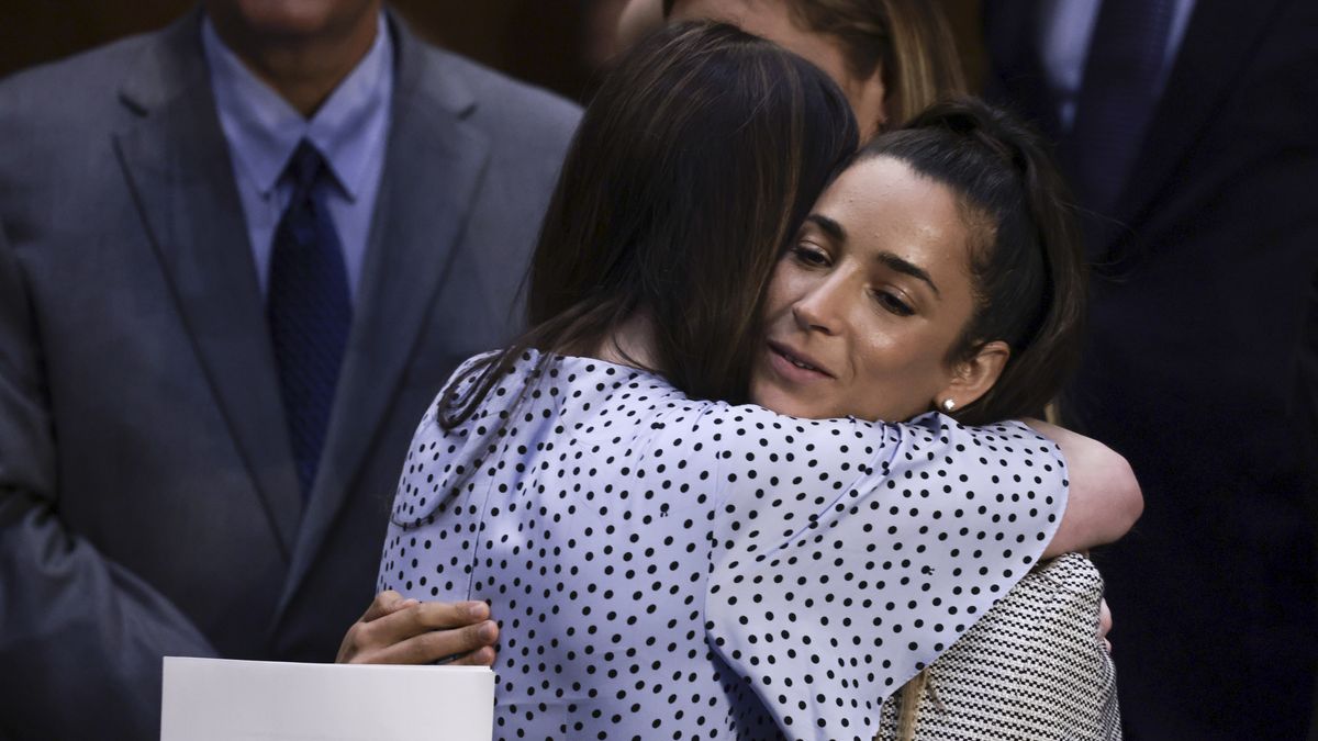 WASHINGTON, DC - SEPTEMBER 15: U.S. Olympic Gymnasts Aly Raisman (R) and McKayla Maroney (L) hug one another after testifying during a Senate Judiciary hearing about the Inspector General's report on the FBI handling of the Larry Nassar investigation of sexual abuse of Olympic gymnasts, on Capitol Hill on September 15, 2021 in Washington, DC. Raisman and other fellow U.S. Gymnasts gave testimony on the abuse they experienced at the hand of Larry Nassar, the former US women's national gymnastics team doctor, and the FBI’s lack of urgency when handling their cases. (Photo by Anna Moneymaker/Getty Images)