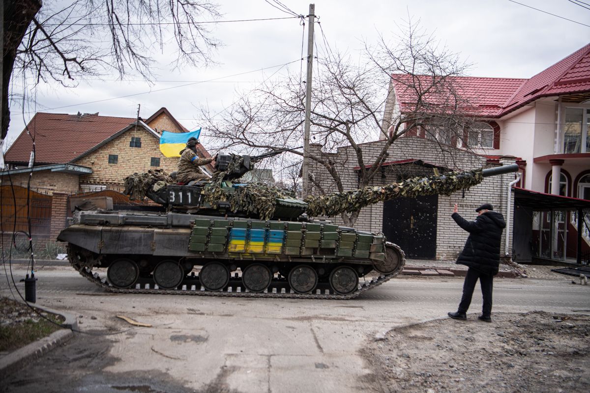 IRPIN, UKRAINE - 2022/04/06: A Ukrainian tank carrying soldiers drives down a road in Irpin, a town near Kyiv from which occupying Russian troops recently withdrew following intense fighting with Ukrainian forces. Russia invaded Ukraine on 24 February 2022, triggering the largest military attack in Europe since World War II. (Photo by Laurel Chor/SOPA Images/LightRocket via Getty Images)