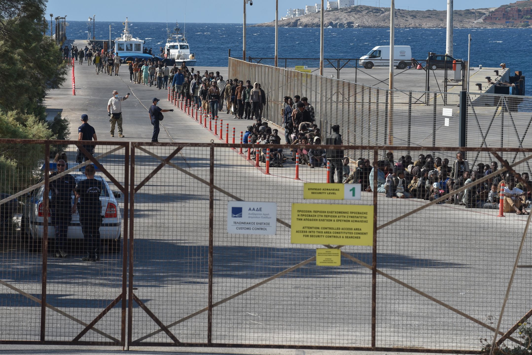 Migrants who arrive on board the bulk carrier Messinian Spire line up for processing at the Port of Lavrio, Greece, on July 10, 2025. The bulk carrier Messinian Spire carries 520 migrants from Libya who are rescued south of Crete. (Photo by Nicolas Koutsokostas/NurPhoto via Getty Images)