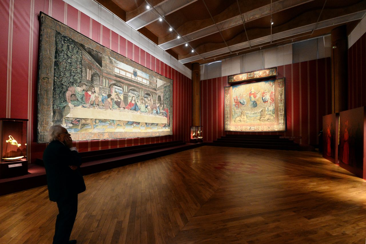 A visitor admires the tapestry masterpieces from Vatican Museums, part of the exhibition of "In The Shadow Of Leonardo"