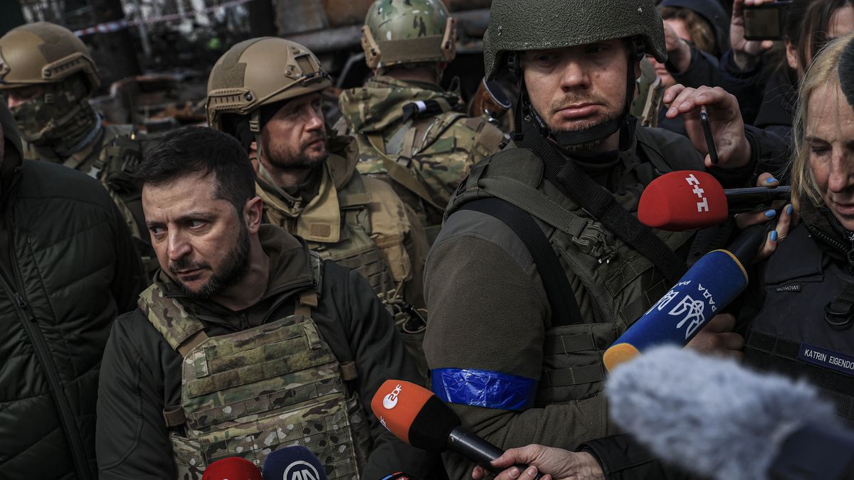 BUCHA, KYIV PROVINCE, UKRAINE, APRIL 04: Ukrainian President Volodymyr Zelenskyy accompanied by Ukrainian soldiers speaks to press during his visit at the town of Bucha, after it was liberated from Russian Army, in Bucha, Ukraine on April 04, 2022. (Photo by Metin Aktas/Anadolu Agency via Getty Images)