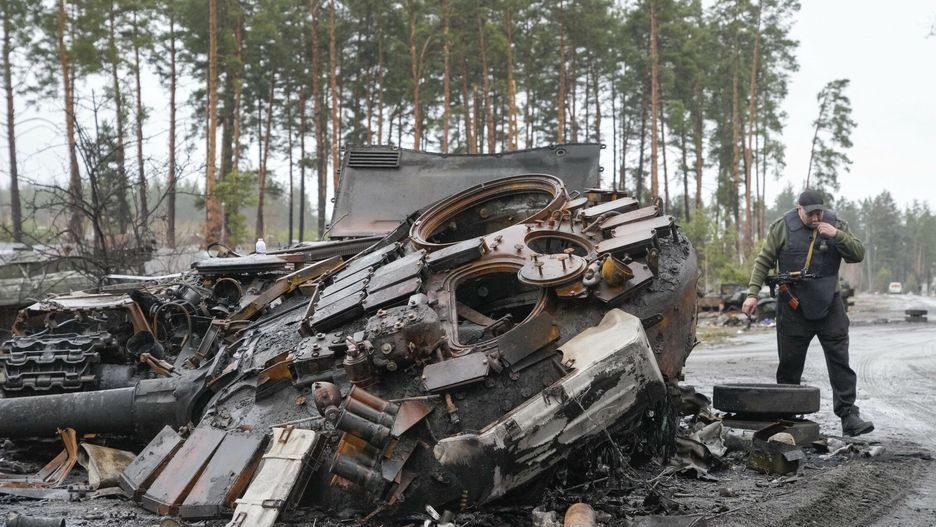 TemporaryA Ukrainian soldier passes by destroyed Russian tanks in the village of Dmytrivka close to Kyiv, Ukraine, Saturday, Apr. 2, 2022. As Russian forces pull back from Ukraine???s capital region, retreating troops are creating a ??scatastrophic" situation for civilians by leaving mines around homes, abandoned equipment and ??seven the bodies of those killed," President Volodymyr Zelenskyy warned Saturday. (AP Photo/Efrem Lukatsky)AP