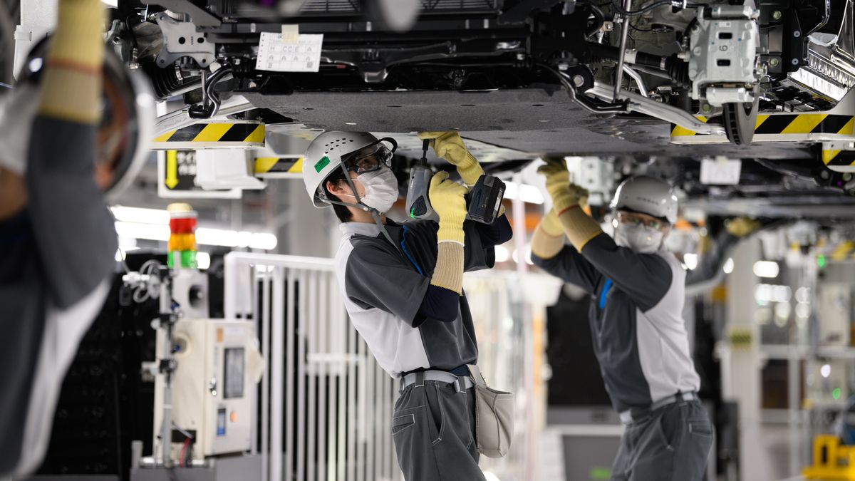 Workers assemble Nissan Motor Co.'s Ariya electric crossover sport utility vehicles (SUV) on the production line of the Nissan Intelligent Factory at the company's plant in Kaminokawa, Tochigi Prefecture, Japan, on Friday, Dec. 8, 2023. The Nissan Tochigi plant and its technologies are designed to serve as a model for global plants. Photographer: Akio Kon/Bloomberg via Getty Images