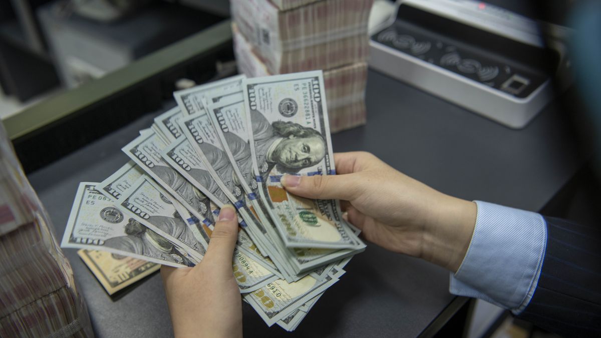 HAI'AN, CHINA - OCTOBER 22 2021: A clerk counts US dollar banknotes at a bank outlet in Hai'an city in east China's Jiangsu province Friday, Oct. 22, 2021. China has over 3.2 trillion dollars worth of foreign reserve by the end of September. (Photo credit should read Feature China/Barcroft Media via Getty Images)