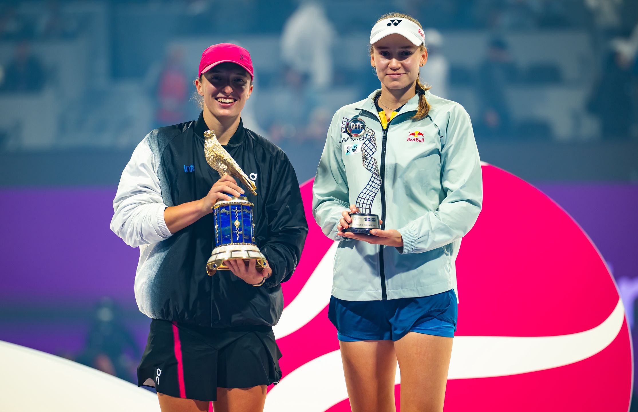 DOHA, QATAR - FEBRUARY 17: Champion Iga Swiatek of Poland and runner-up Elena Rybakina of Kazakhstan pose with their trophies after the singles final on Day 7 of the Qatar TotalEnergies Open, part of the Hologic WTA Tour at Khalifa International Tennis and Squash Complex on February 17, 2024 in Doha, Qatar (Photo by Robert Prange/Getty Images)