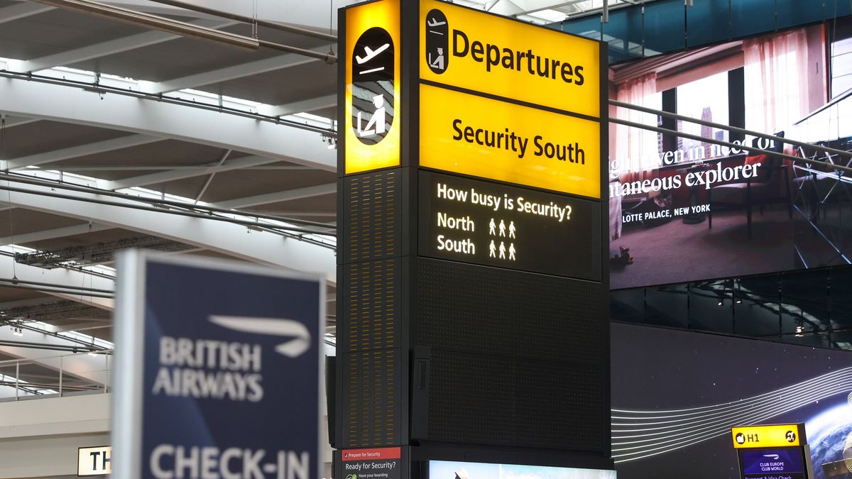 A sign indicating the length of the security queue is during a strike by security workers at London Heathrow Airport in London, UK, on Friday, March 31, 2023. IAG SAs British Airways is set to scrap 320 flights during the Easter week as security workers strike for 10-days over pay. Photographer: Chris Ratcliffe/Bloomberg via Getty Images