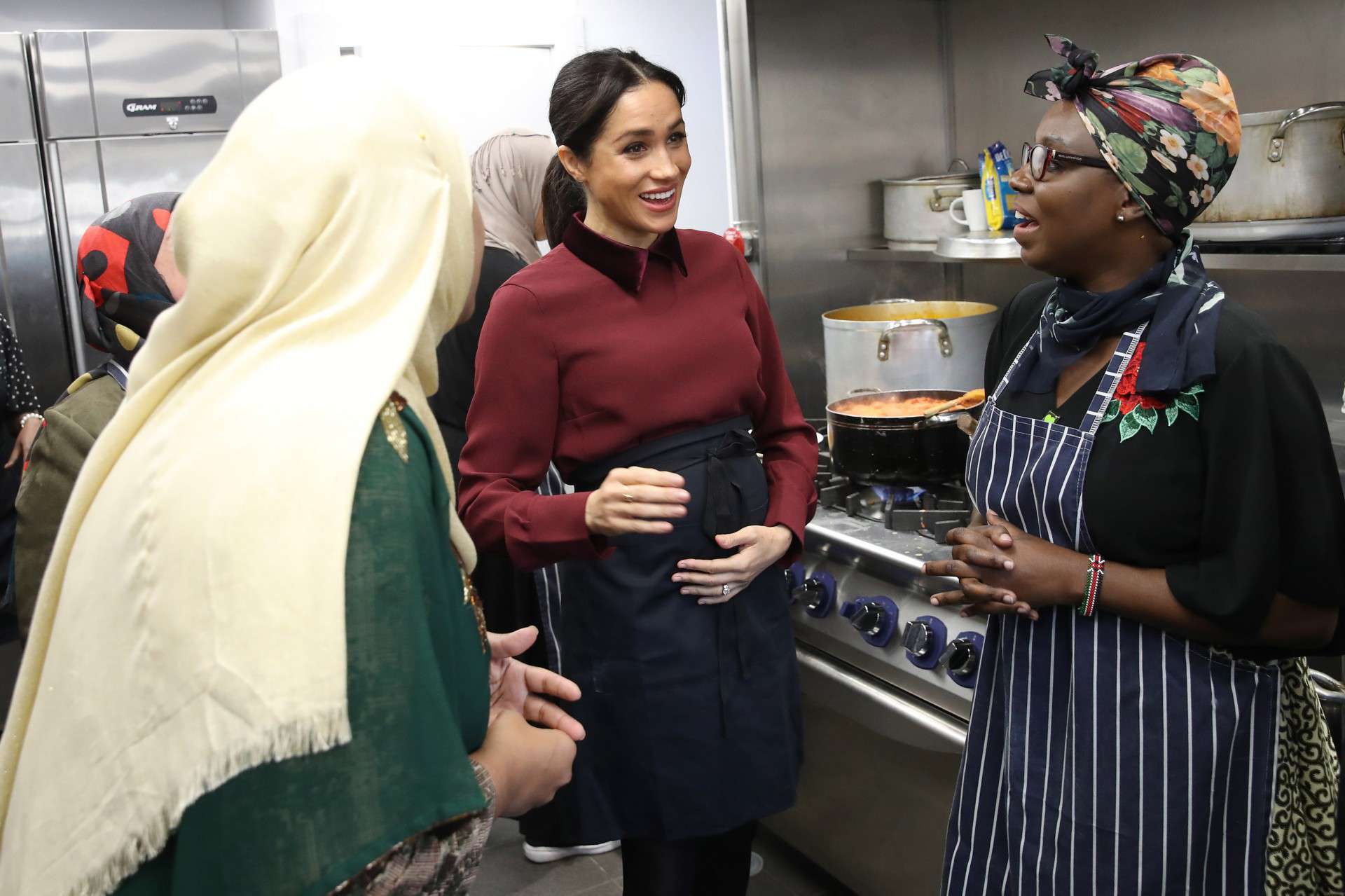 LONDON, ENGLAND - NOVEMBER 21: Meghan, Duchess of Sussex talks to chef Clare Smyth as she visits the Hubb Community Kitchen to see how funds raised by the 'Together: Our Community' Cookbook are making a difference at Al Manaar, North Kensington on November 21, 2018 in London, England.