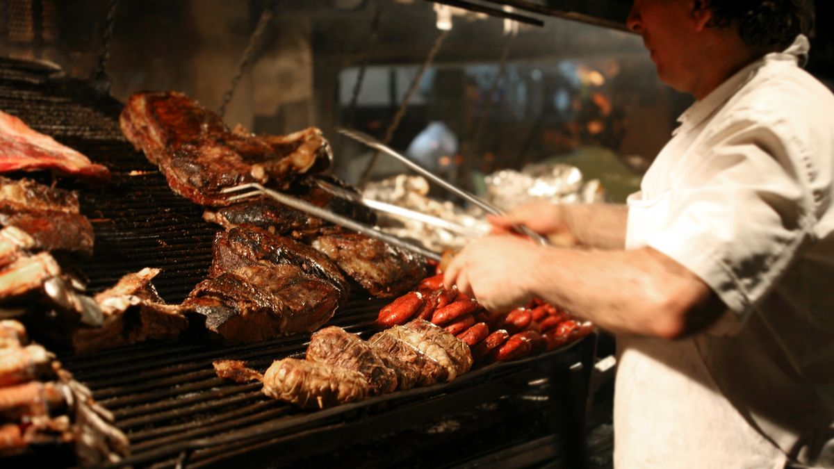 Argentinian chef cooking meat in the restaurant