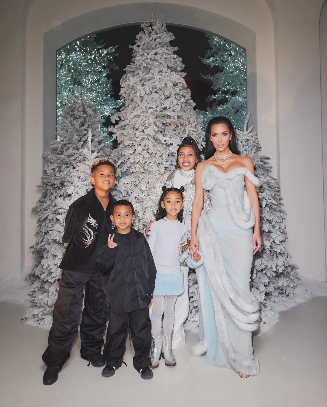 Kim Kardashian with kids at a holiday party