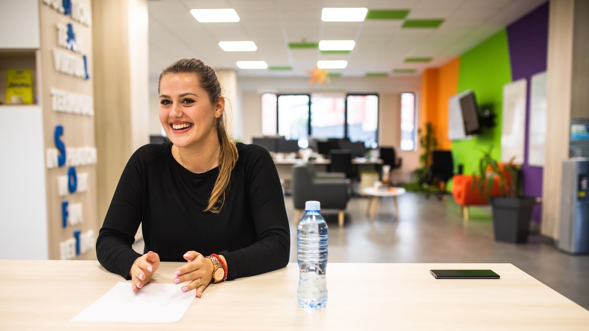 A young woman glowing in a job interviewA young woman is in a job interview in an officeAleksandar  Jankovic