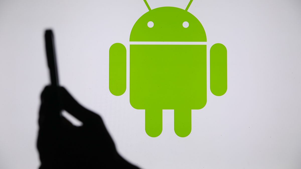 The Android logo displays on a screen with a person holding a phone in Knurow, Poland, on September 20, 2025. (Photo by Klaudia Radecka/NurPhoto via Getty Images)