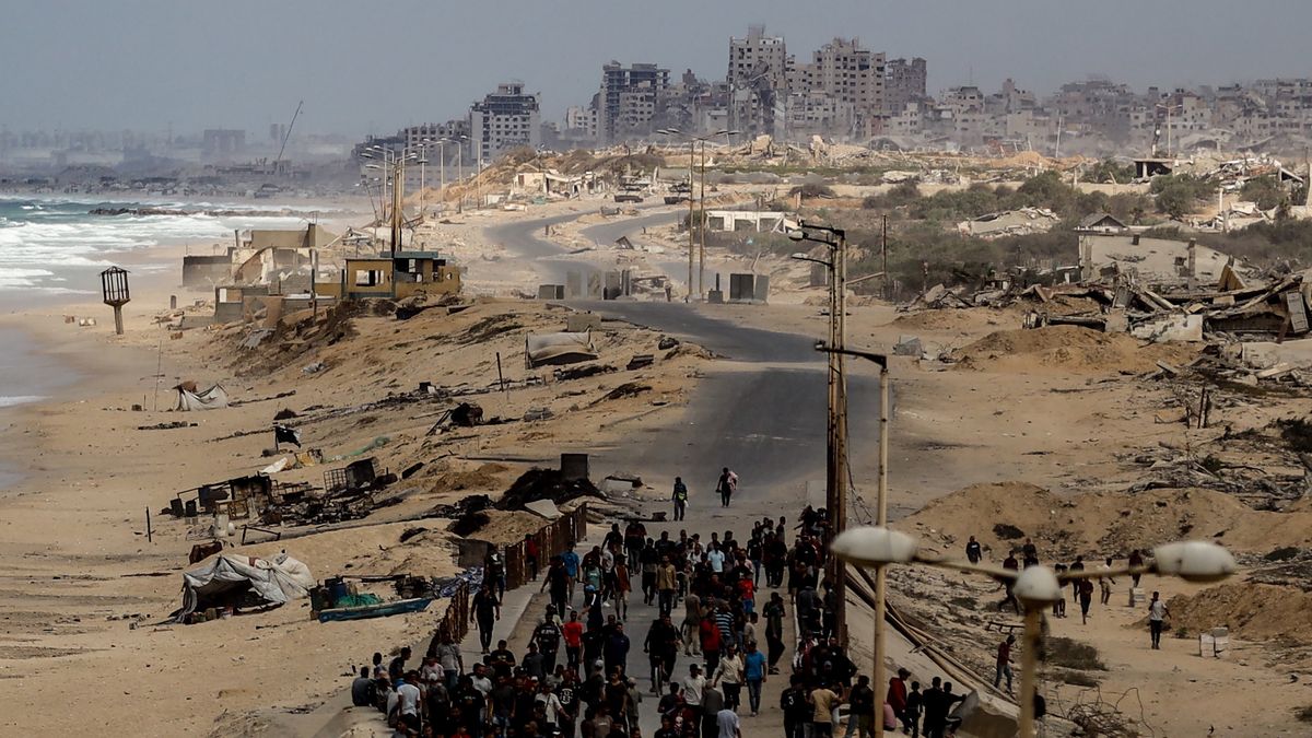 DEIR AL-BALAH, GAZA - OCTOBER 09: Palestinians turn back before advancing further as Israeli forces attack to prevent them from crossing north through Rashid Street, despite the ceasefire agreement reached and expected to take effect, in Deir al-Balah, Gaza, on October 09, 2025. (Photo by Khames Alrefi/Anadolu via Getty Images)