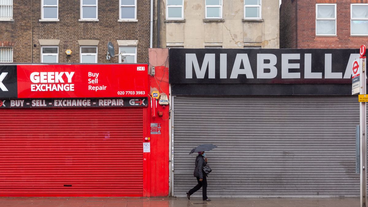 A Londoner in protective face mask is seen shopping for essential needs on a rainy day in Elephant and Castle district as the UK's government introduced strict Coronavirus restrictions earlier this month due to sharp increase in numbers of Covid-19 cases in the UK - London, England on January 13, 2021. Only essential shops can be opened. Exercising and going to work are exceptions for Stay at Home policy. (Photo by Dominika Zarzycka/NurPhoto via Getty Images)