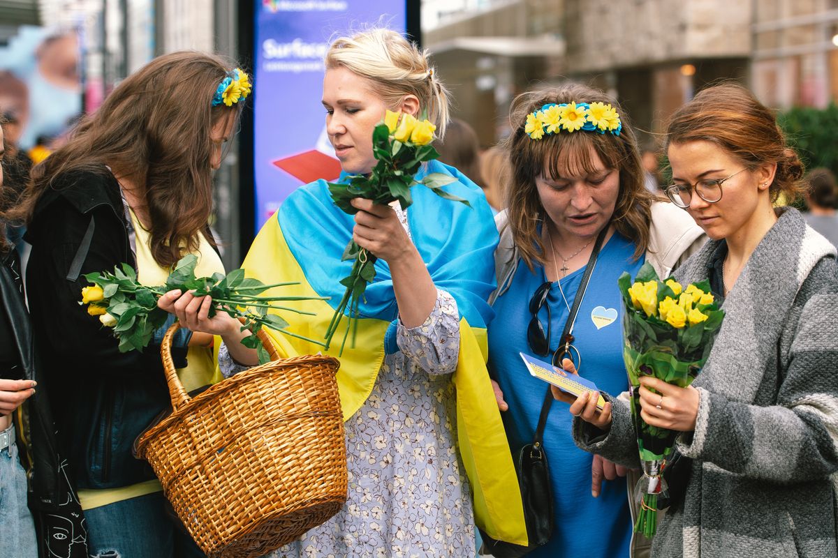 a group of  Ukraine refugees hand out some flowers and Thank you cards on the street of Duesseldorf, Germany on April 14, 2022 as part of appreication toward the German public supporting and hosting Ukrain refugees.during the war time. (Photo by Ying Tang/NurPhoto via Getty Images)