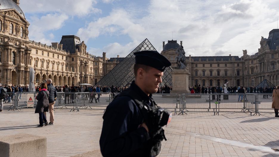 A police officer at the Louvre Museum in Paris, France, on Monday, Oct. 27, 2025. France's Socialist Party will decide by the end of the week whether to topple the government over taxes on the wealthy. Photographer: Nathan Laine/Bloomberg via Getty Images