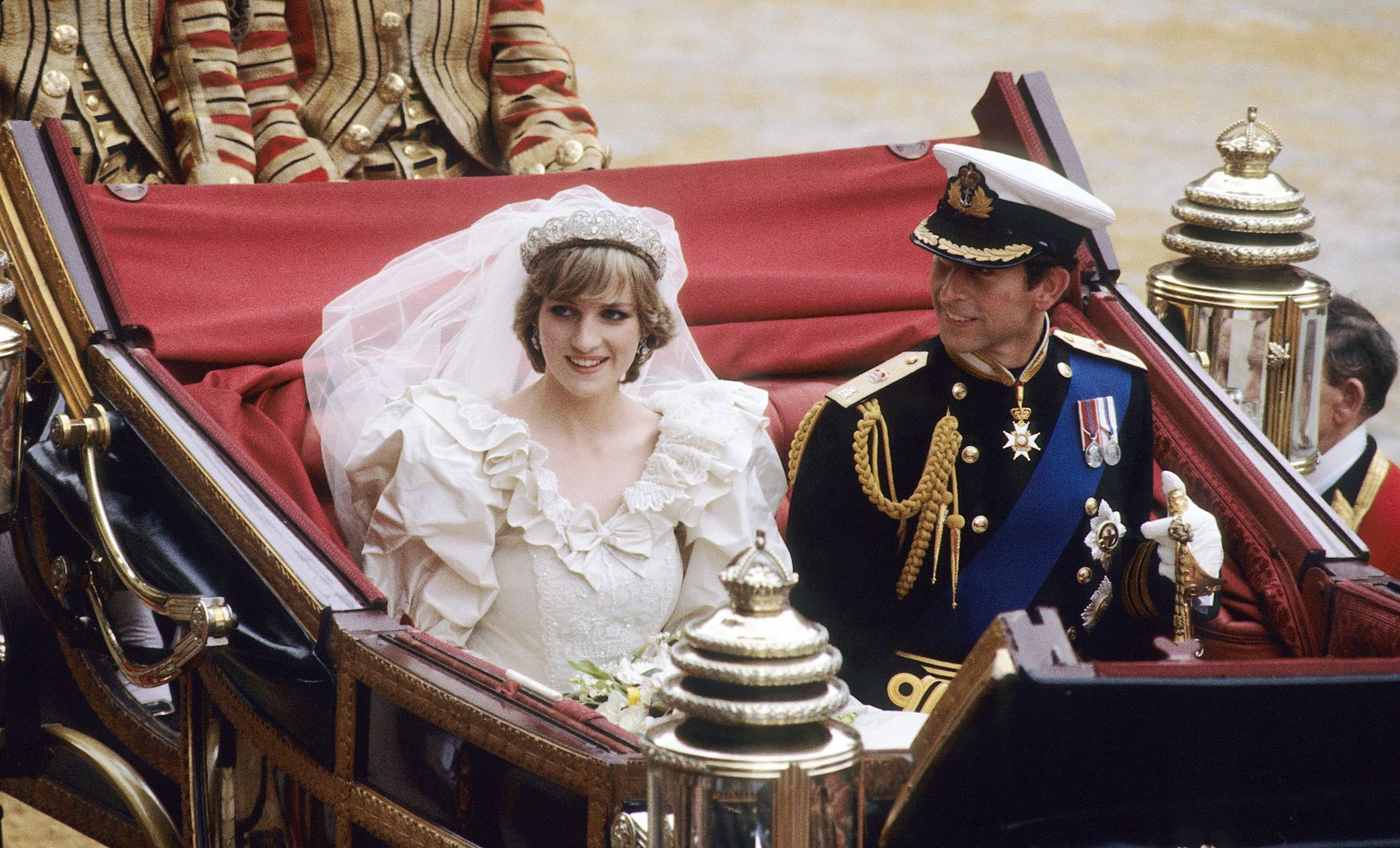 In memory of Diana, Princess of Wales, who was killed in an automobile accident in Paris, France on August 31, 1997.
LONDON, ENGLAND - JULY 29: Prince Charles, Prince of Wales and Diana, Princess of Wales, wearing a wedding dress designed by David and Elizabeth Emanuel and the Spencer family Tiara, ride in an open carriage, from St. Paul's Cathedral to Buckingham Palace, following their wedding on July 29, 1981 in London, England.   (Photo by Anwar Hussein/WireImage)
Anwar Hussein
Fashion, Half length, marriage, Royals, uniform, wedding