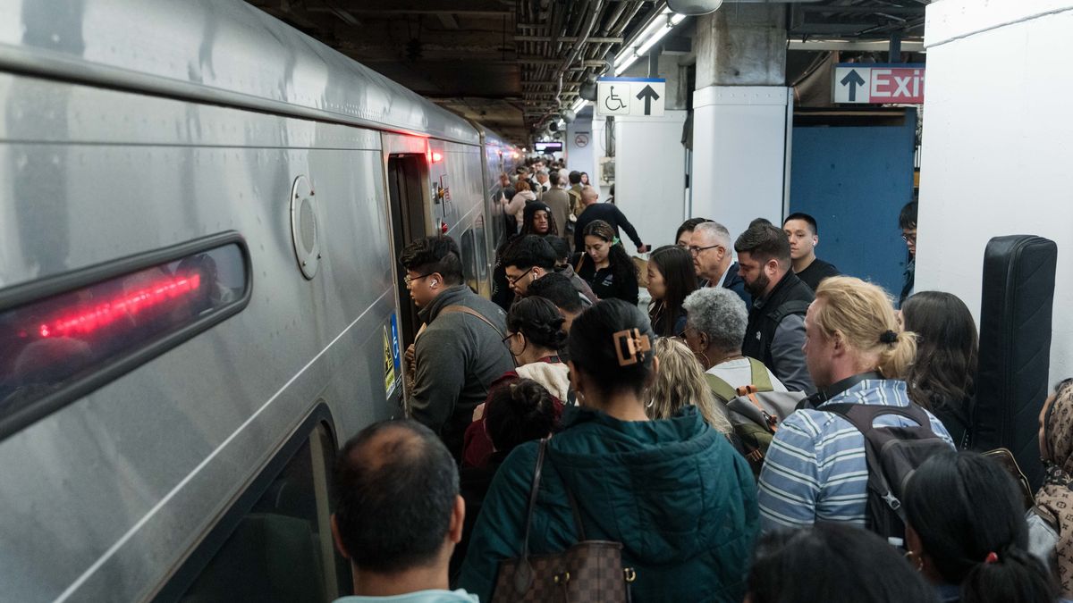 Travelers board a Long Island Rail Road (LIRR) train at Penn Station in New York, US, on Friday, May 22, 2026. AAA projects that 45 million people will travel at least 50 miles from home over the Memorial Day weekend, which would set a Memorial Day record. Photographer: Adam Gray/Bloomberg via Getty Images