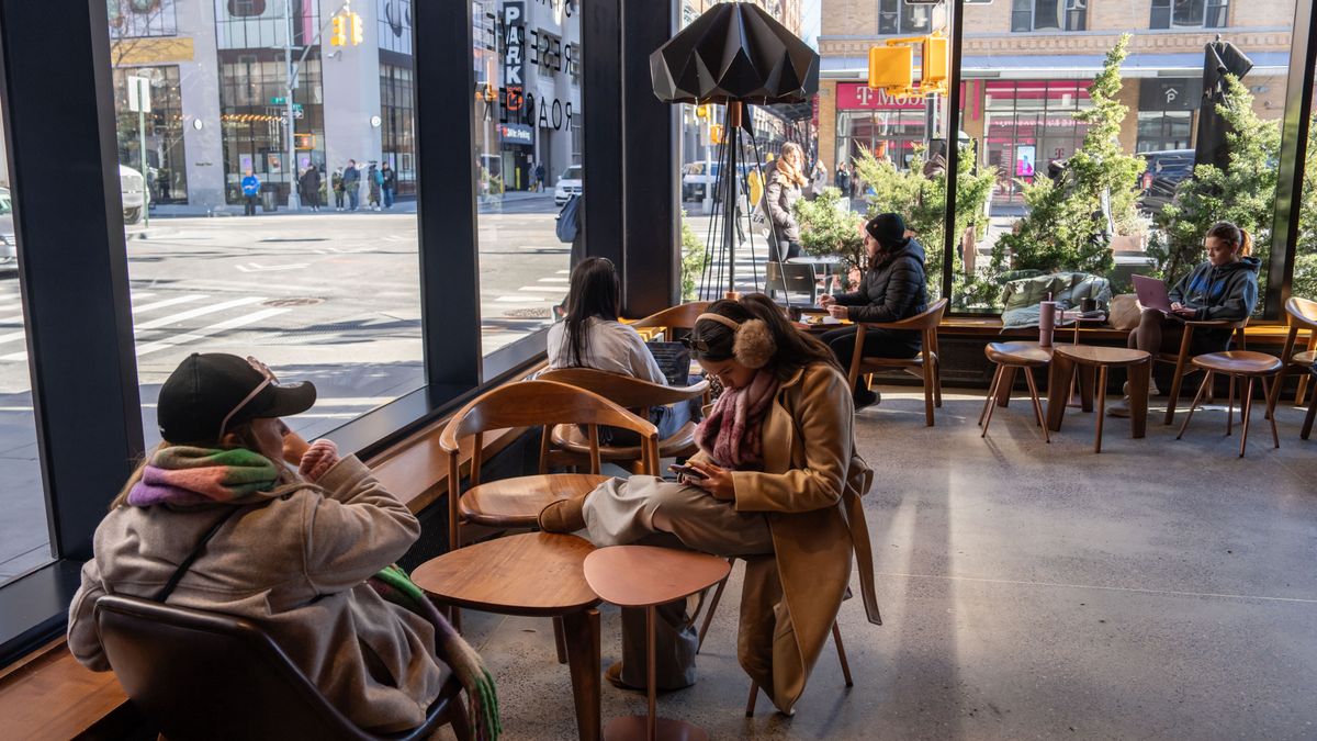 NEW YORK, NEW YORK - JANUARY 14: People sit inside of a Starbucks on January 14, 2025 in New York City. Starbucks is officially changing its code of conduct and ending a longtime policy that permitted people to sit and stay at coffee shop locations without making a purchase. (Photo by Adam Gray/Getty Images)