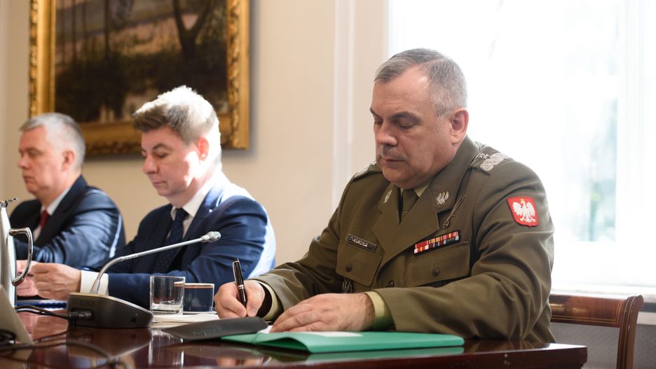 Chief of the General Staff of the Polish Armed Forces Wieslaw Kukula (R) is signing a document before the National Security Council gathering in Warsaw, Poland, on July 8, 2024. The President of Poland is holding a meeting with the National Security Council ahead of his flight to Washington, U.S., for the NATO summit that marks the 75th alliance's anniversary. (Photo by Aleksander Kalka/NurPhoto via Getty Images)