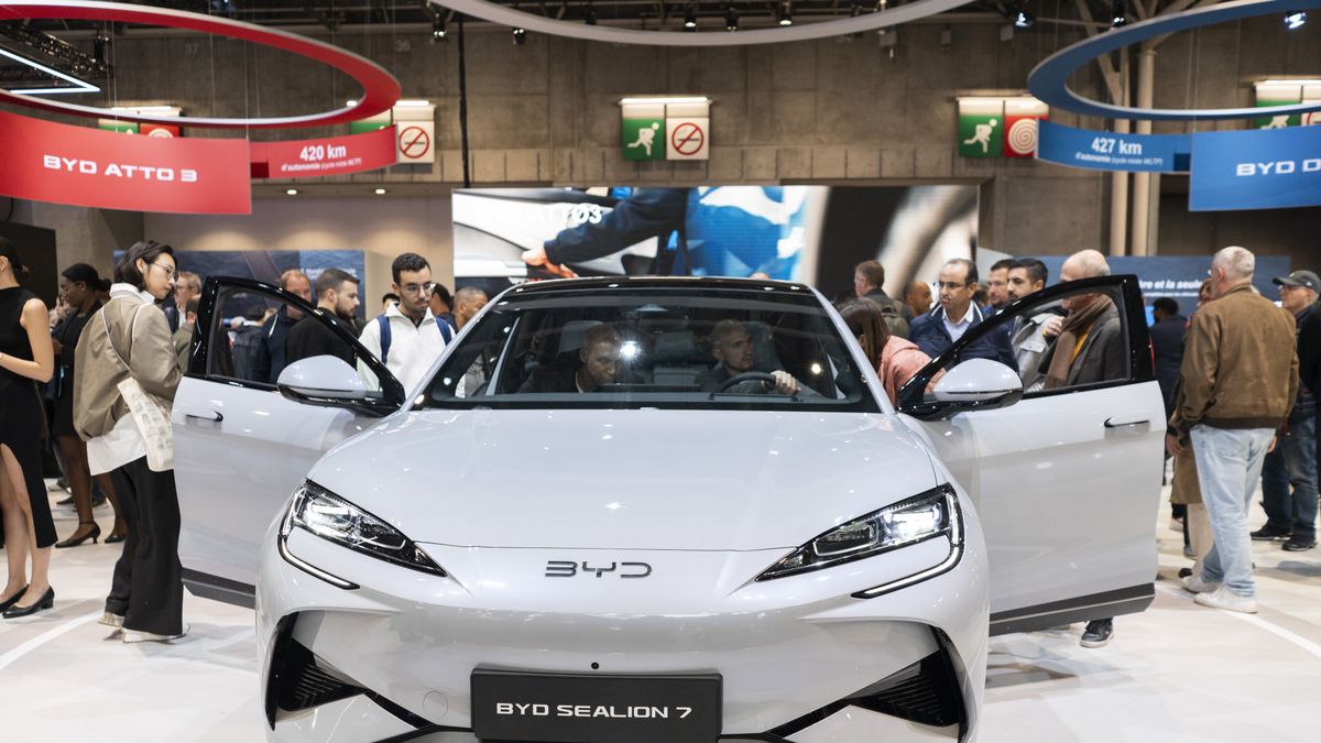 Visitors inspect a BYD Sealion 7 electric vehicle at the Paris Motor Show in Paris, France, on Tuesday, Oct. 15, 2024. The 90th edition of the Paris Motor Show runs 14-20 October. Photographer: Nathan Laine/Bloomberg via Getty Images