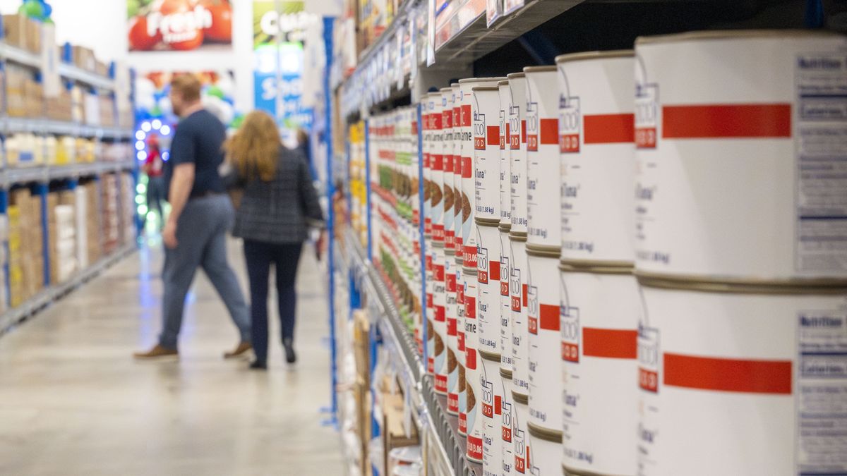 HOUSTON, TEXAS - MAY 7: Customers walk down the aisle as a variety bulk sized canned meats are seen on the shelves at the new Sysco To Go A Restaurant Club location on Katy Freeway in Houston, Wednesday, May 7, 2025. (Kirk Sides/Houston Chronicle via Getty Images)