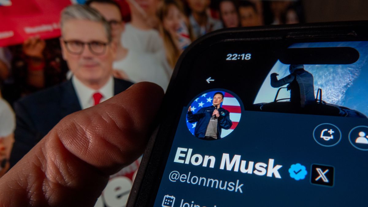 BATH, UNITED KINGDOM - JANUARY 07: In this photo illustration the profile page of tech billionaire Elon Musk owner of US online social media and social networking site 'X' (formerly known as Twitter) is displayed on a smartphone screen in front of the opening website page of the UK's ruling Labour Party on January 7, 2025 in Bath, England. The UK Prime Minister Sir Keir Starmer has recently hit back at Elon Musk who has been posting on his social media platform attacks on the Prime Minister and the Labour government over the grooming scandal and has been accused of reigniting the political row about gangs of men who groomed and raped girls in England over several decades and has accused Keir Starmer and other senior politicians of covering up the scandal. (Photo Illustration by Anna Barclay/Getty Images)