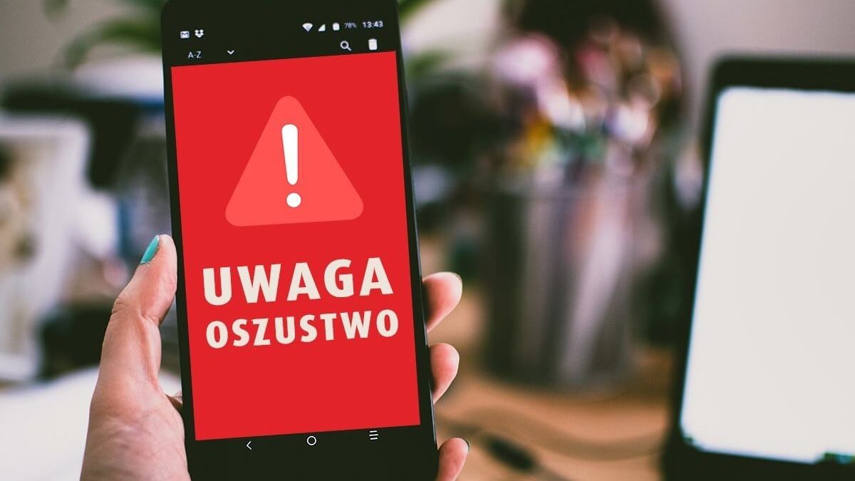 Telefon z napisem uwaga oszustwo